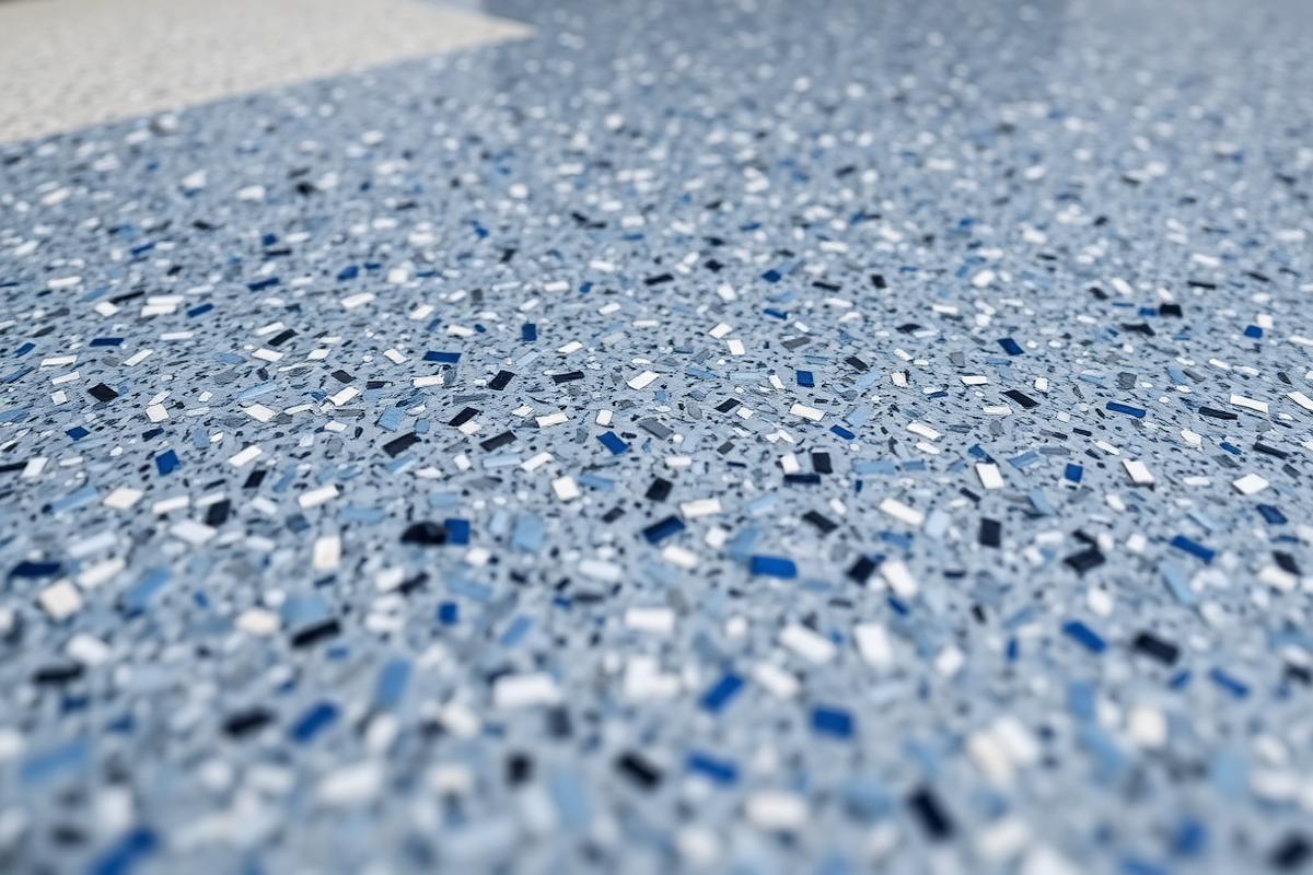 Close-up of a decorative flake garage floor coating under a clear topcoat